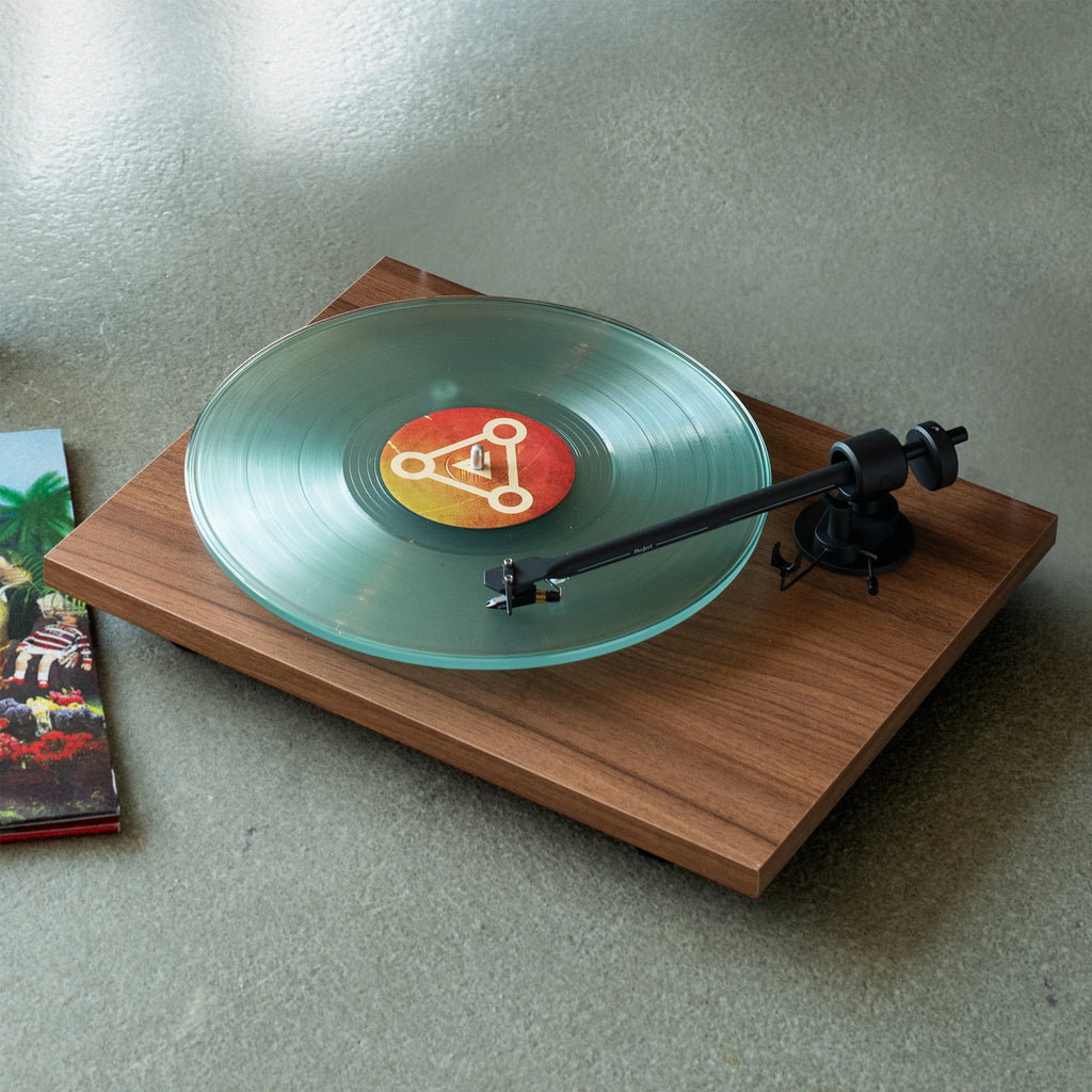 Pro-Ject T1 Turntable with record playing on the ground